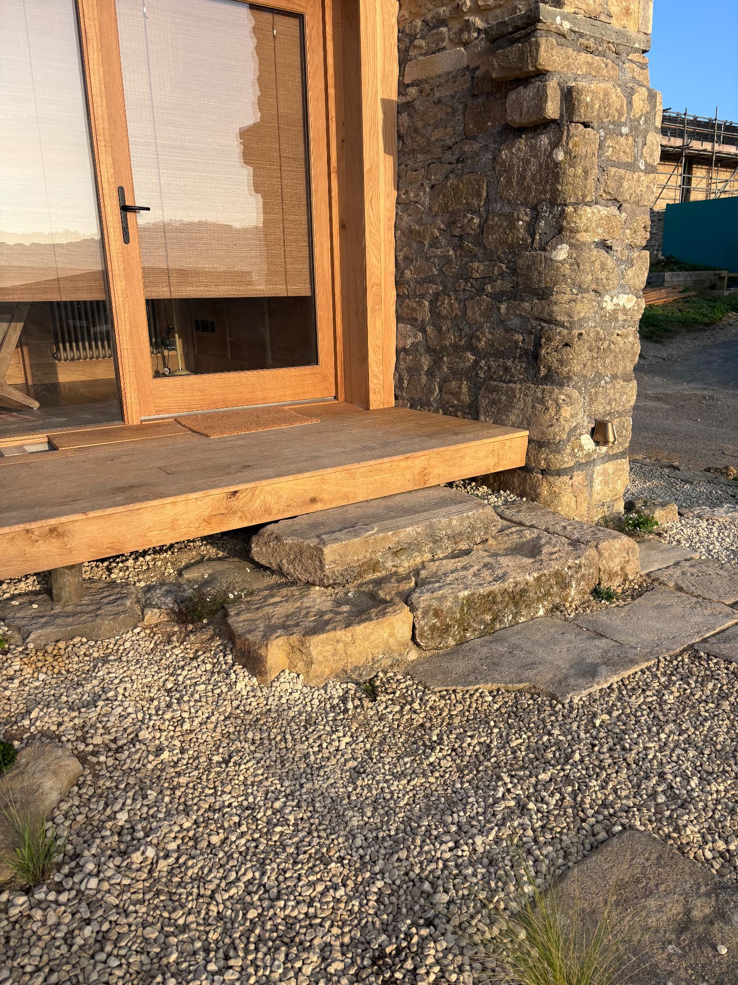 Large stone steps up to the oak-framed door of the garden studio at Studio Garden, Somerset